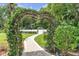 Romantic heart-shaped trellis walkway leading to backyard gate at 3450 Ohio Ave, Sanford, FL 32773