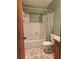 Bathroom features a shower-tub combination, white tiles, and a wood vanity at 360 Kentia Rd, Casselberry, FL 32707