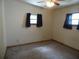 Modest bedroom with ceiling fan, carpet floors, and two windows providing natural light at 360 Kentia Rd, Casselberry, FL 32707