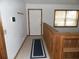 Bright entryway with tile flooring, a wooden railing, and a large window providing natural light at 360 Kentia Rd, Casselberry, FL 32707
