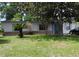 Charming single-story home featuring light-colored siding, light blue shutters, a bright blue door, and a well-maintained front lawn at 360 Kentia Rd, Casselberry, FL 32707