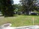 Well-manicured lawn in front of home. Mature trees create curb appeal in residential neighborhood at 360 Kentia Rd, Casselberry, FL 32707