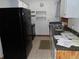 Functional kitchen with black appliances, a double basin sink, and upper and lower cabinets for storage at 360 Kentia Rd, Casselberry, FL 32707