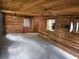 View of an empty Living Room featuring wood-paneled walls, new grey carpet, and natural light at 360 Kentia Rd, Casselberry, FL 32707