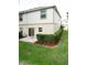 A home's manicured backyard with healthy green grass, defined concrete patio, and beautiful boxwood shrubs at 3850 Hampstead Ln, Lakeland, FL 33810