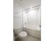 Bright bathroom with a standard toilet and tub with white subway tile at 3850 Hampstead Ln, Lakeland, FL 33810
