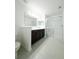 Bright bathroom features a double vanity with dark cabinets and a glass-enclosed shower at 3850 Hampstead Ln, Lakeland, FL 33810