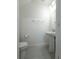 Bathroom featuring a pedestal sink, a toilet, and a towel rack at 3850 Hampstead Ln, Lakeland, FL 33810