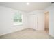 Bedroom with carpeted floors, window view, and double door closet at 3850 Hampstead Ln, Lakeland, FL 33810