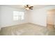 Bright bedroom with neutral carpet, ceiling fan, and walk-in closet at 3850 Hampstead Ln, Lakeland, FL 33810