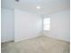 Neutral bedroom featuring plush carpet, a single window, and an electrical outlet at 3850 Hampstead Ln, Lakeland, FL 33810