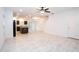Bright, open-concept living area with recessed lighting, neutral tile flooring, and ceiling fan at 3850 Hampstead Ln, Lakeland, FL 33810