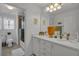 Bright bathroom featuring a double vanity, quartz countertops, modern fixtures, and tiled floors at 3869 Shoreside Dr, Kissimmee, FL 34746