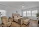 Bright bedroom with a ceiling fan, wood floors, and abundant natural light from large windows at 3869 Shoreside Dr, Kissimmee, FL 34746