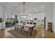 Open dining area flowing into kitchen featuring modern lighting and a breakfast bar at 3869 Shoreside Dr, Kissimmee, FL 34746