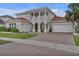 Beautiful two-story home featuring a brick driveway and a two-car garage at 3869 Shoreside Dr, Kissimmee, FL 34746
