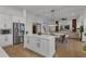 Open-concept kitchen boasts large island, stainless appliances, and seamless flow into dining and living areas at 3869 Shoreside Dr, Kissimmee, FL 34746