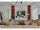 Modern living room with large comfortable seating, decorative wood paneling and a beautiful area rug at 3869 Shoreside Dr, Kissimmee, FL 34746