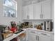 A butler's pantry with built-in cabinets provides ample storage for household supplies at 3869 Shoreside Dr, Kissimmee, FL 34746