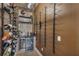 Elegant wine room with custom racking, beverage cooler, and stylish display area at 3869 Shoreside Dr, Kissimmee, FL 34746