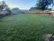 A well-maintained, large, grassy backyard with a wooden fence at 5390 Botany Ct, Orlando, FL 32811