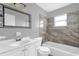 Bathroom features a modern vanity, tub, and tiled shower, enhanced by natural light at 5390 Botany Ct, Orlando, FL 32811