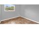 Bright bedroom features neutral walls, base molding, and complementary-colored floors at 5390 Botany Ct, Orlando, FL 32811