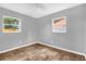 This bedroom has two windows that provide views of the neighborhood and the gray walls are illuminated by the natural light at 5390 Botany Ct, Orlando, FL 32811