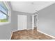 The neutral colored bedroom features a window with lush landscaping views and a closet at 5390 Botany Ct, Orlando, FL 32811