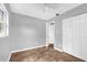 This bedroom features neutral gray walls, a ceiling fan, closet and a view to the hallway at 5390 Botany Ct, Orlando, FL 32811