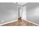 Bright bedroom featuring neutral walls, base molding, and complementary-colored floors at 5390 Botany Ct, Orlando, FL 32811