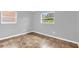 This bedroom features two windows with views of the neighborhood at 5390 Botany Ct, Orlando, FL 32811
