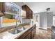 Kitchen features granite countertops, stainless steel faucet and spacious sink at 5390 Botany Ct, Orlando, FL 32811