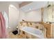 Bathroom featuring soaking tub with decorative tile surround and a private toilet area at 615 Maple Forest Dr, Orlando, FL 32825