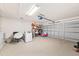 Spacious two car garage featuring painted brick walls, a sealed floor and overhead lighting at 615 Maple Forest Dr, Orlando, FL 32825