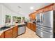 Bright kitchen featuring stainless steel appliances, granite counters, and tile flooring at 615 Maple Forest Dr, Orlando, FL 32825