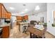 Open-concept kitchen features granite countertops, wood cabinets and breakfast bar seating at 615 Maple Forest Dr, Orlando, FL 32825