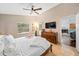 Cozy bedroom featuring tile floors, a ceiling fan, and a view into another room at 615 Maple Forest Dr, Orlando, FL 32825
