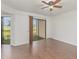 Bedroom with hardwood floors, sliding glass doors to patio, and neutral decor at 7863 Sugar Bend Dr # 7863, Orlando, FL 32819