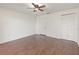 Bright bedroom with hardwood floors, ceiling fan, and closet at 7863 Sugar Bend Dr # 7863, Orlando, FL 32819
