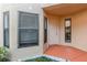 Cozy foyer featuring a white front door, neutral tones, and decorative rock landscaping at 7863 Sugar Bend Dr # 7863, Orlando, FL 32819