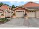 Charming townhome featuring attached garages, vibrant landscaping, and a well-maintained exterior at 7863 Sugar Bend Dr # 7863, Orlando, FL 32819