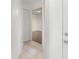 Neutral hallway with tile flooring and a peek into the adjacent room at 7863 Sugar Bend Dr # 7863, Orlando, FL 32819