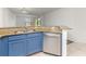 Kitchen island with stainless steel sink, granite countertop, and blue cabinetry at 7863 Sugar Bend Dr # 7863, Orlando, FL 32819