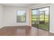 Bright living room with dark wood floors, a sliding glass door, and natural light at 7863 Sugar Bend Dr # 7863, Orlando, FL 32819