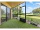 Screened patio with artificial turf flooring and view of a grassy area at 7863 Sugar Bend Dr # 7863, Orlando, FL 32819