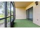 Screened patio with artificial turf flooring and sliding glass door access to the living area at 7863 Sugar Bend Dr # 7863, Orlando, FL 32819