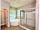 Bathroom with tub, glass shower, and pebble tiled floor at 8044 Rural Retreat Ct, Orlando, FL 32819