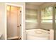 Bathroom featuring a garden tub with dual windows and a separate toilet at 8044 Rural Retreat Ct, Orlando, FL 32819