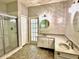 Well-lit bathroom with a glass shower, and double vanity at 8044 Rural Retreat Ct, Orlando, FL 32819